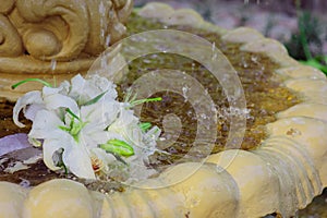 The Wedding Bridal Bouquet Of White Roses Lies In An Old Fountain Under Splashes And Drops Of Water.