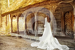 Wedding Bride Dress Rear View Outdoors. Vintage White Bridal Gown over Old Wooden Terrace. Romantic Woman Portrait