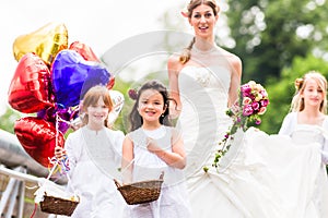 Wedding Bride in gown with bridesmaid