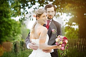 Wedding bride and groom in a meadow photo