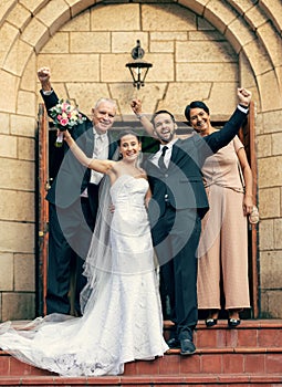 Wedding, bride and groom with parents on stairs, church and happiness at excited celebration. Marriage, couple and