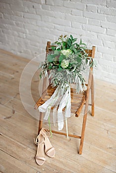 Wedding bride`s wedding accessories. Flower ,shoes and chair.