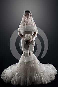 Wedding Bride in Veil on face, Elegant Lady in Luxury Bridal Dress, Studio Portrait