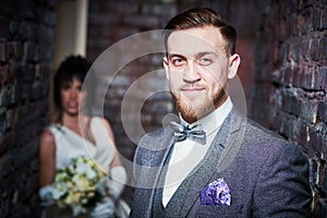 Wedding. bridegroom or fiance portrait with bride on background