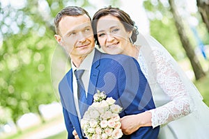 Wedding. bridegroom or fiance portrait with bride in park