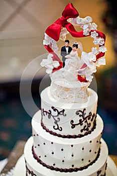 Wedding cake with a bride and groom topper