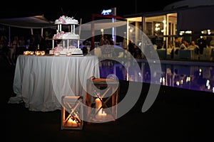 Wedding cake with candles and roses