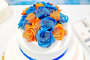 Wedding cake covered mastic with decorative roses close up