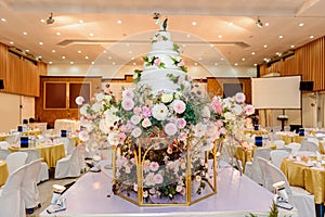 Wedding cake with Decorated with flowers and Candlestick at marriage ceremony