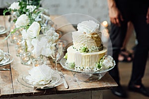 Wedding cake decorated loft style with a table and accessories