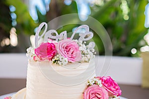 Wedding cake decorated with rose flowers. High quality photo.