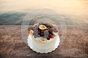 Wedding cake of figs, cherries and berries with a white cream. O