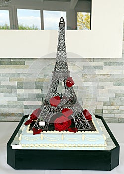 Wedding cake as eiffel tower with red roses photo