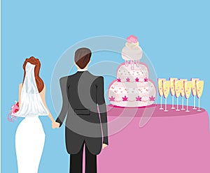 Wedding cake and a pair of honeymooners photo