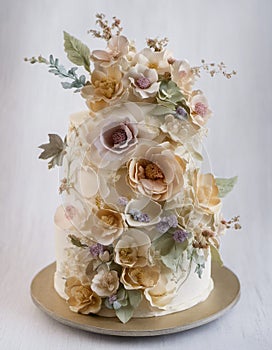 Wedding cake in pastel colours, with flowers and leaves