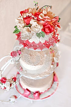 Wedding cake with red flowers.