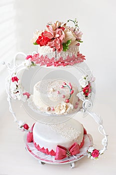 Wedding cake with red flowers.