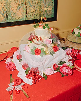 Wedding cake with rose decorations and topper.