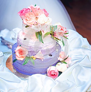 Wedding cake with ruches and roses in pink-violet color