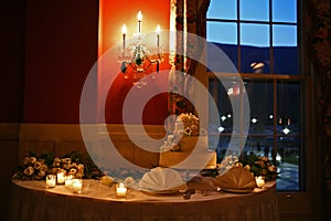 Wedding cake on table with candles