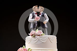 Wedding cake topper with two grooms, figurines of a gay couple. Gay marriage concept. Same-sex gay marriage, wedding sweets and