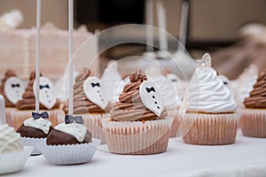 Wedding candy bar cap cakes white brown.