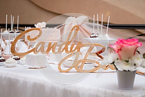 Wedding candy bar. wooden inscription on the table