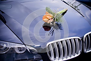 Wedding car with bridal flowers