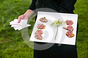 Wedding caterer carrying a plate of food