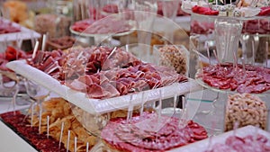 Wedding catering meat products, appetizers for celebration. Appetizing food spread on the table.