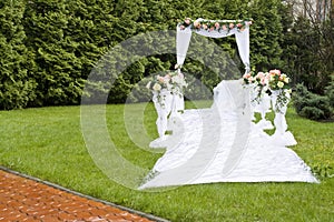 Wedding celebration arch on grass in park