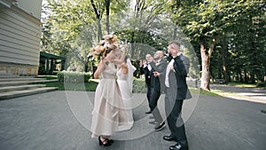 Wedding Celebration March: Bridal Party Walking with Excitement, The bridal party, including the bride and groom, walks