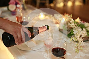 Wedding celebration. Pouring shampagne in glasses