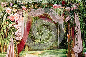 Wedding ceremony arch, altar decorated with flowers on the lawn