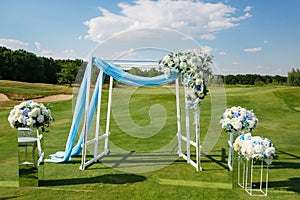 Wedding Ceremony Arch decoreted with Hydrangea Flower Arrangements on green lawn before
