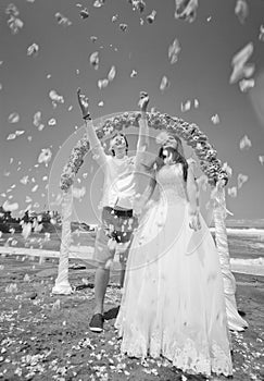 Wedding ceremony on the beach with happy honeymooners