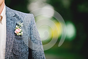 Wedding ceremony. Groom in a suit. Buttonhole on the jacket