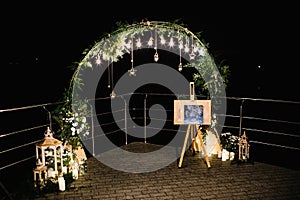 Wedding ceremony in nature. The lights of the electric garland i