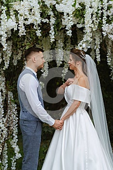 wedding ceremony of the newlyweds on the glade