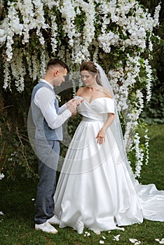 wedding ceremony of the newlyweds on the glade