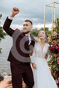 Wedding ceremony of the newlyweds on the pier