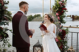 Wedding ceremony of the newlyweds on the pier