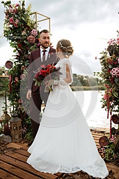 Wedding ceremony of the newlyweds on the pier