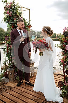 Wedding ceremony of the newlyweds on the pier