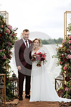 Wedding ceremony of the newlyweds on the pier