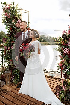 Wedding ceremony of the newlyweds on the pier