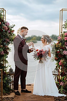 Wedding ceremony of the newlyweds on the pier