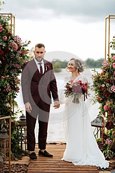 Wedding ceremony of the newlyweds on the pier