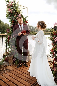 Wedding ceremony of the newlyweds on the pier