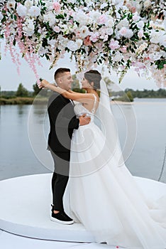 wedding ceremony of the newlyweds on the pier